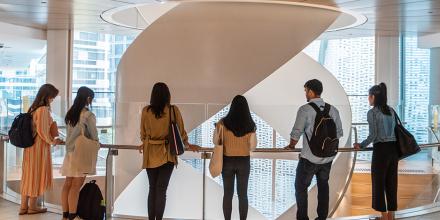 Six students staring down the staircase of building 2