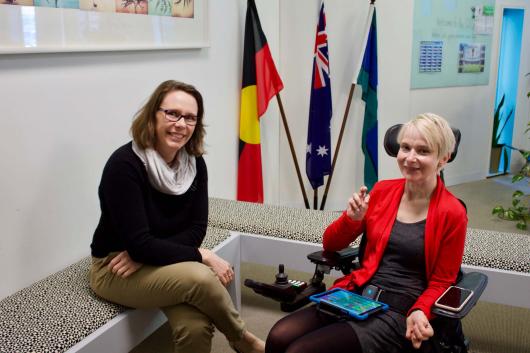 Harmony Turnbull, seated and Fiona Bridger in wheelchair with communication device.