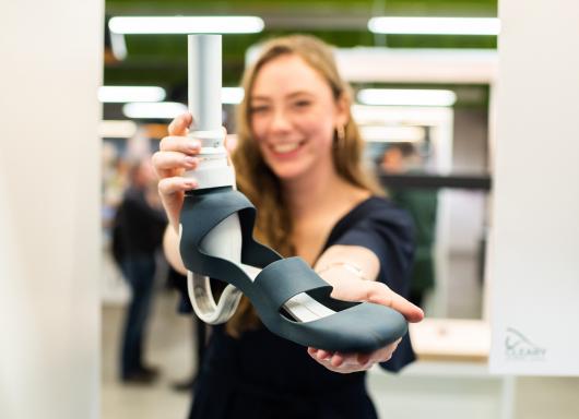 Eloise Cleary holding her prosthetic heel design. 