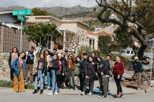 A group of photography students stand on a Californian street corner.