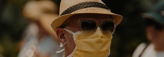 Man wearing mask and sun hat