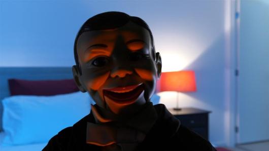 image from Greg Ferris' SFF2022 film of the head of ventriloquist doll in dark blue lighting