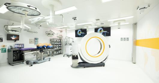 A Stryker Aero CT scan sits in the middle of a white laboratory.