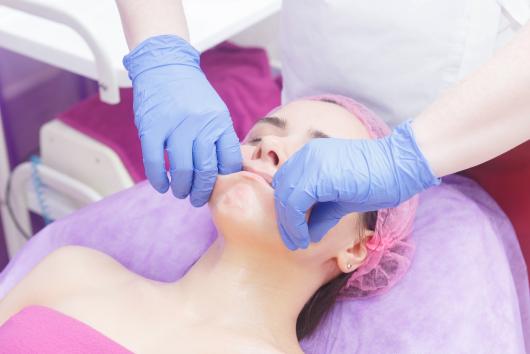 Buccal massage of a woman's face. Image: Adobe Stock