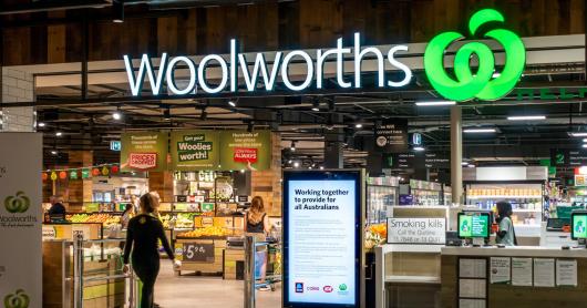 The entrance of a Woolworths supermarket with the signage prominently displayed.