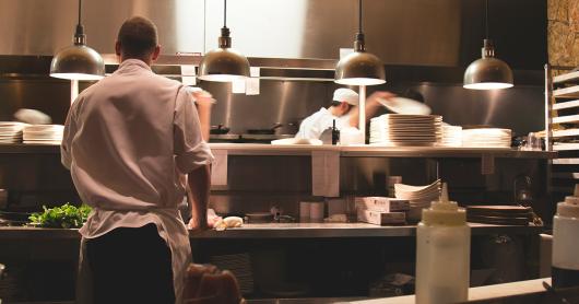 Workers prepare food in a restaurant kitchen