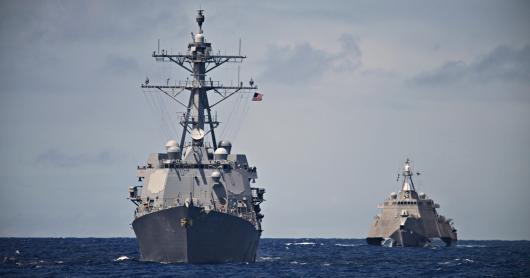 A USS Destroyer and Littoral Combat Ship hunt together in the South Pacific. Taken during a Pacific Deployment in 2014.