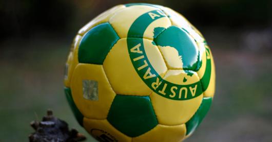 Yellow and green football showing map of Australia and the word Australia