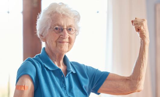 Elderly woman flexes arm muscles