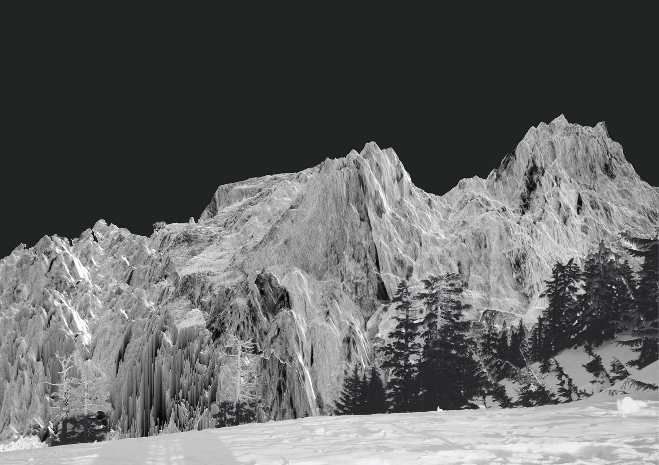 Black and white photograph of rocky mountain peaks covered in ice