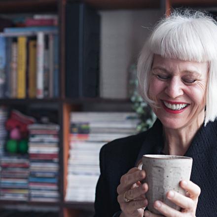 Lady smiling holding a mug