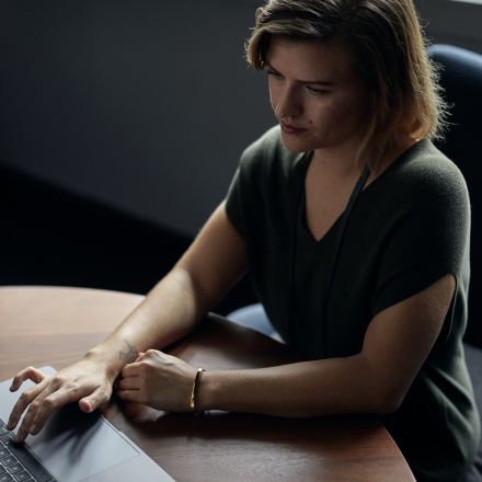 A corporate woman working on a laptop