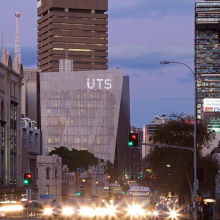 Street level photo of the UTS campus from Broadway (road) showing Building 11 and Building 01 at dusk