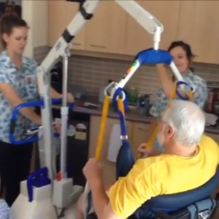 Two nurses assist an elderly patient in using the SmartHoist device