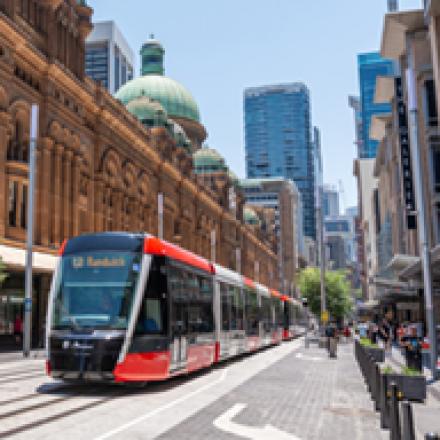 A light rail train carriage approaches in the Sydney CBD
