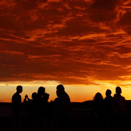 People silhouetted against blazing sunset