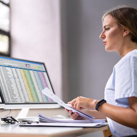 Woman looking at spreadsheets on a computer