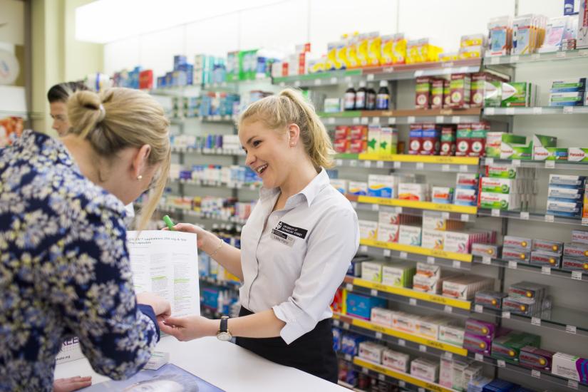 Female customer at chemist talking to pharmacist