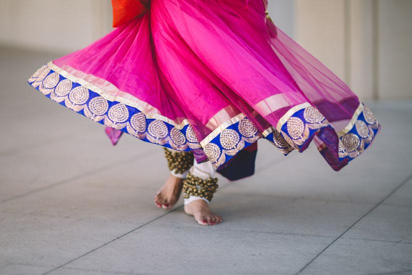 Bright pink sari with gold and purple trimming.