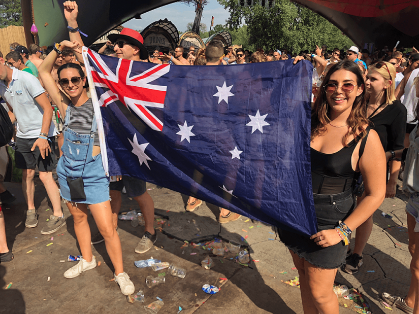 FASS Italy ICS study tour two girls at an Italian festival holding a large Australian flag