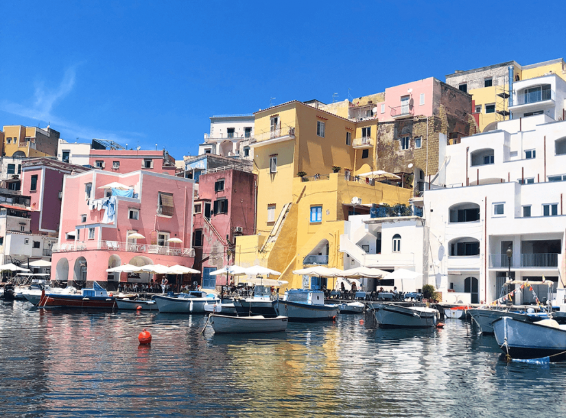 FASS Italy ICS study tour Italian village waterfront with colorful boats and buildings