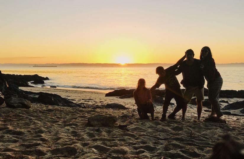 Silhouettes of a group of 4 people on a beach in Chile