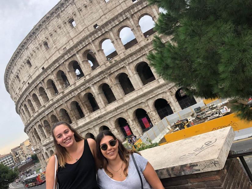 FASS ICS Italy study tour two girls smiling in front of the Colosseum