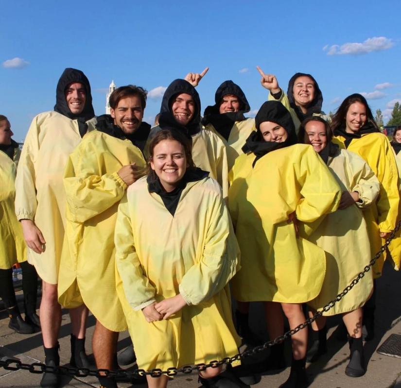 Sahara with a group of 10 UTS In-Country Study students wearing yellow raincoats 