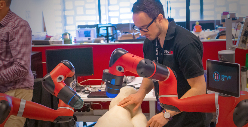 CAS researcher preparing robotic arms with 3d printed sheep