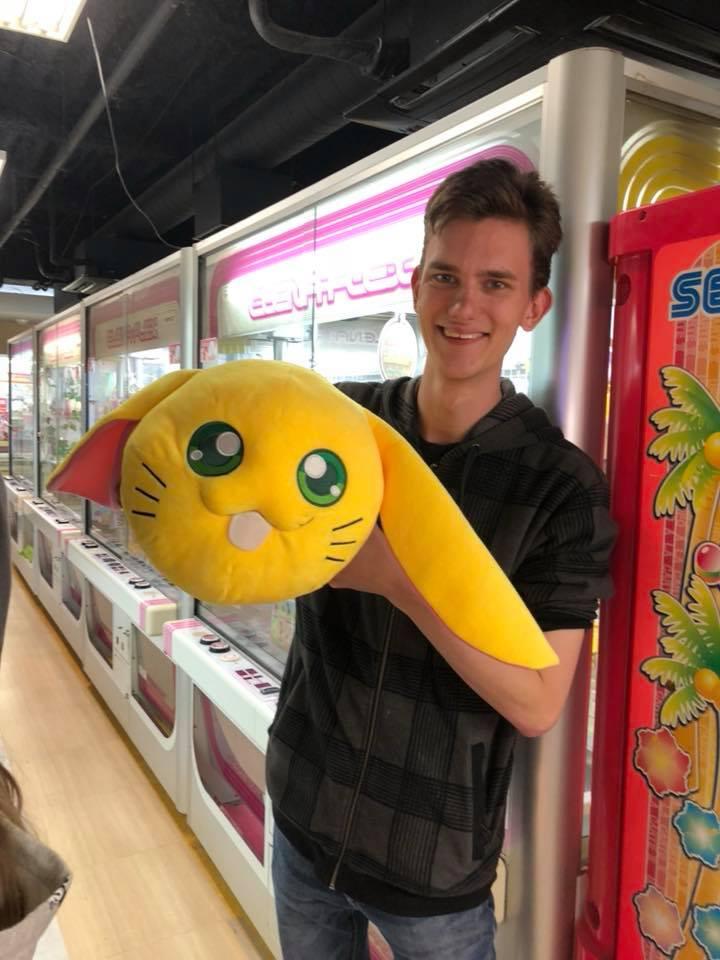 James holding up a Japanese toy in an arcade
