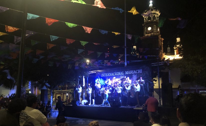 A mariachi band performing at night