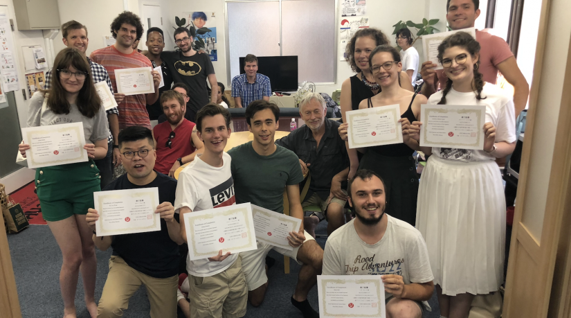 A class of students holding up certificates