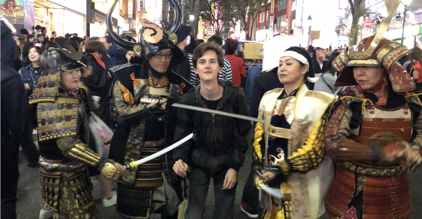 James posing with people dressed up as samurai soldiers