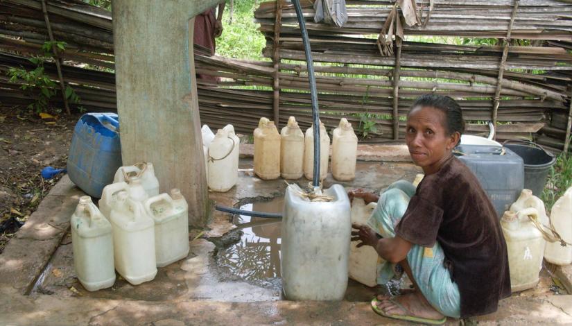 Woman collecting water in Timor Leste 