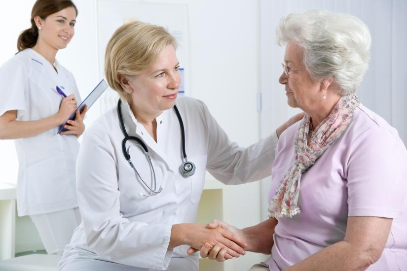 Image of female doctor and pharmacist with elderly patient 