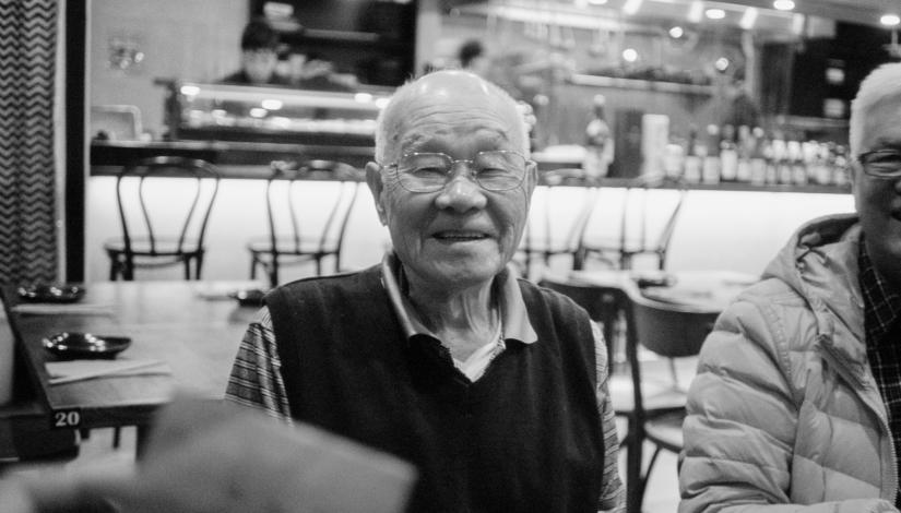 Black and white portrait of Rachel Tse's grandpa sitting in a cafe