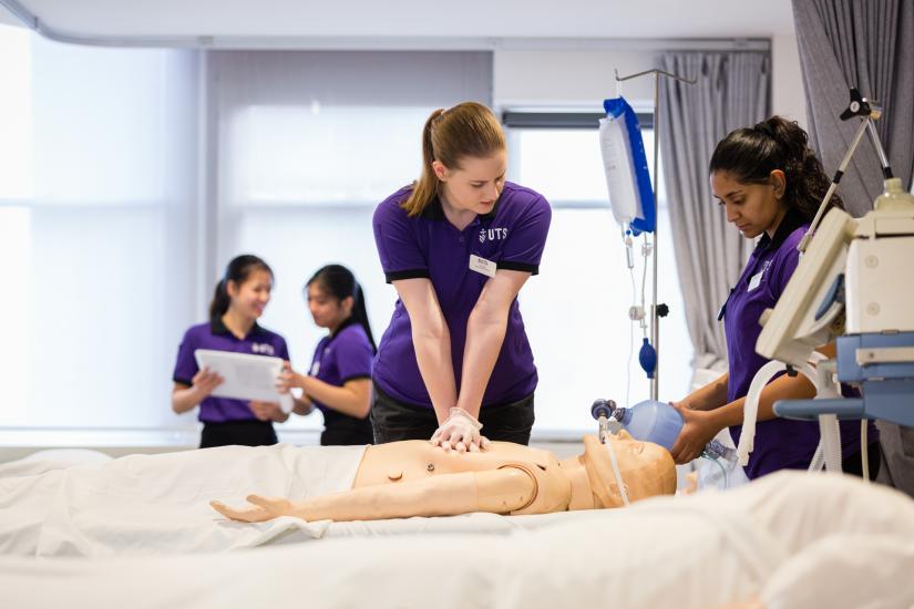 Nursing students practicing on a model patient