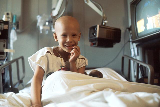 Paediatric patient in bed, smiling