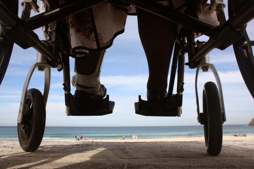 View of beach from underneath a wheelchair