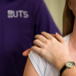 UTS Nursing student comforts a patient with hand on shoulder