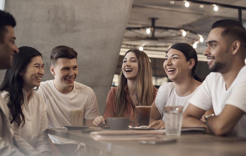 Group of young people at a table laughing