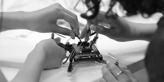 School student and UTS academic working on a drone.