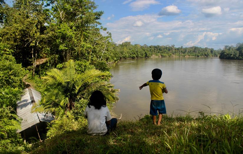 Children searching for pink dolphins in the Pastaza river, Suwa.