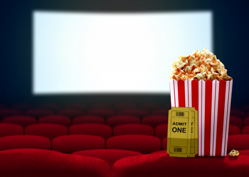 image of an empty cinema, white screen, back of the red seats, with an inset image of a red and white striped carton of popcorn, and yellow ticket stubs