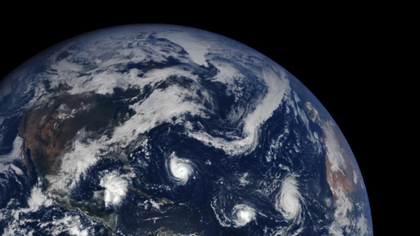 Partial world globe with clouds and hurricanes