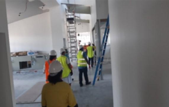 Workers in high vision surveying inside