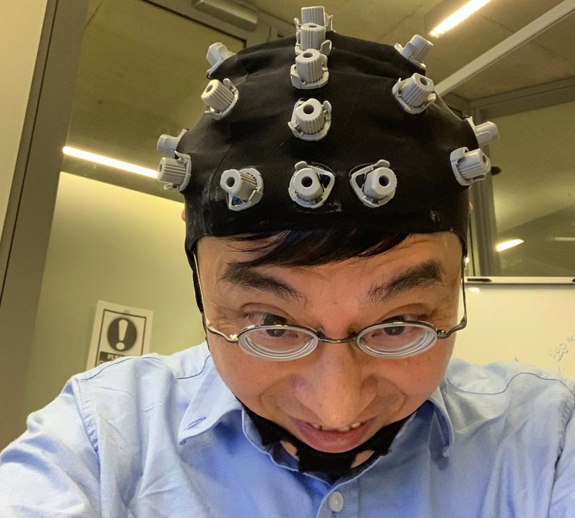 CT Lin wears a wireless EEG device for an experiment