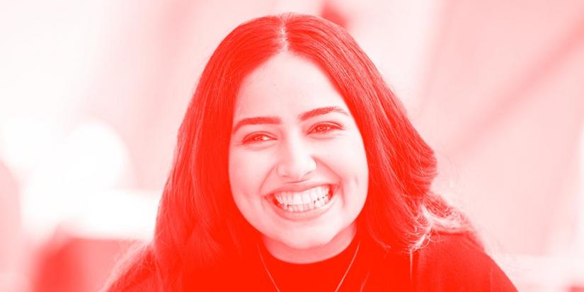 Red and white filtered photo of a woman smiling.