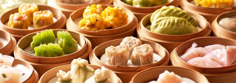 A close-up photos of various steamed dumplings in bamboo baskets