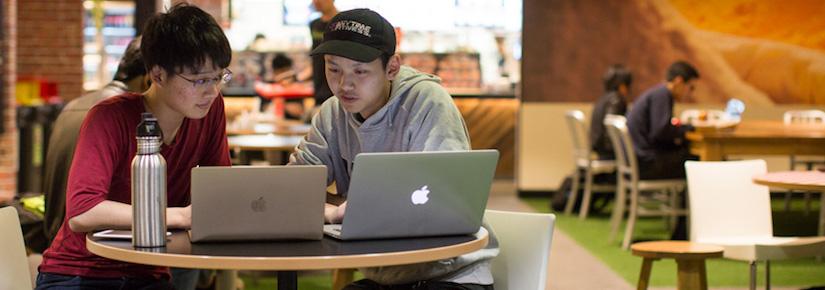 UTS students working with their Apple laptops inside a cafe